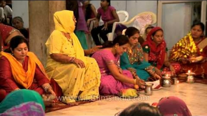 Ladies performing Karva Chauth rituals