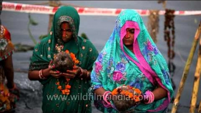 Devotees paying obeisance to the Sun on the occasion of Chhath Puja