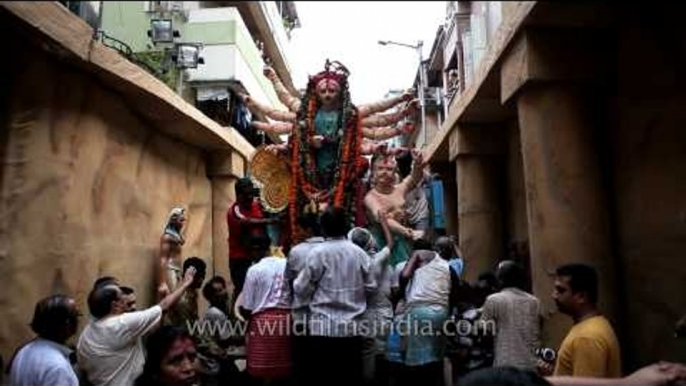 Durga idol being lifted on truck to be taken for immersion: Kolkata Durga puja