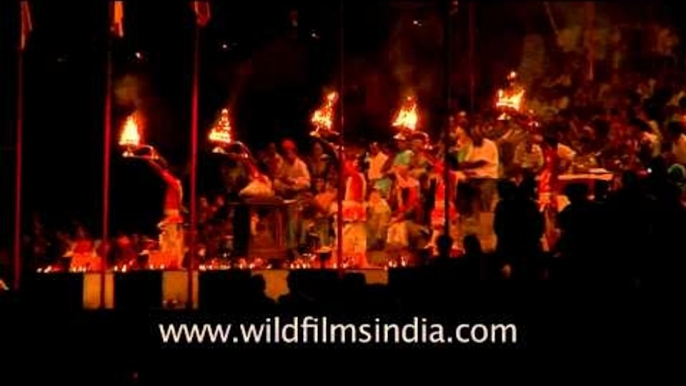 Priests waving multi-tiered lamp during evening aarti - Uttar Pradesh