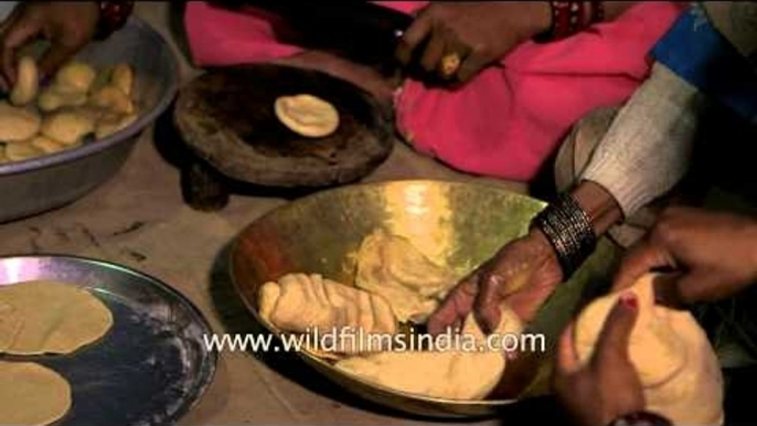 Women kneading wheat dough to make puri