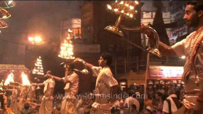 Multi tiered lamps being raised by HIndu priests during Ganga Aarti in Varanasi