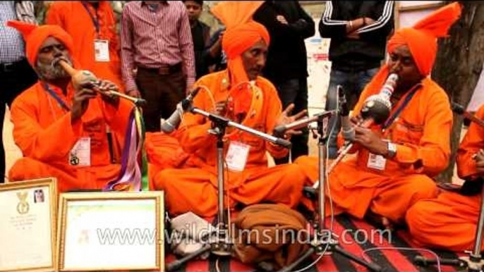 Artists in traditional attire compiling folk beats at Surajkund Mela