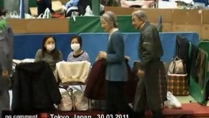 Japan's Emperor Akihito visits tsunami victims - no comment