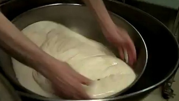 Fold The Dough .. Mr. Herman punches the dough to revitalize the yeast. Royal Oak, Michigan bakery. Small business.