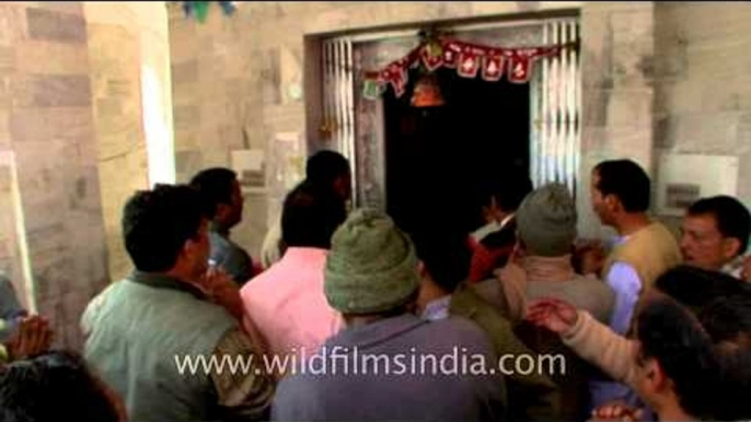 Devotees chant mantras in praise of Goddess Durga (at temple threshhold)