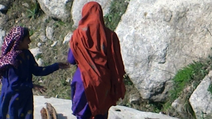 Hardworking kids collecting woods from forest near waterfall Neelum Valley Kutton Azad Kashmir Pakistan on 11 April 2015