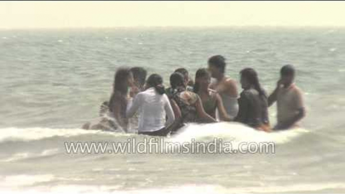 Visitors frolicking at a beach in India