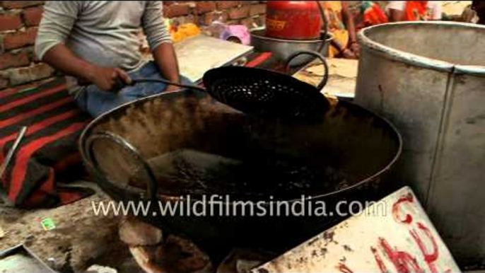 Women kneading wheat dough to make puri in Aligarh