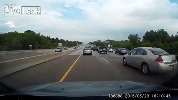 Rolling tire hits car on highway