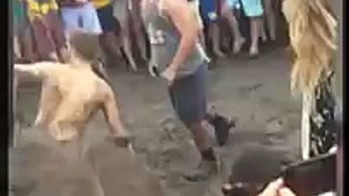 Guys fight in the mud during the concert