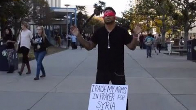 Arms up for Syria & world: Man stands blindfolded with raised arms for hours in social experiment