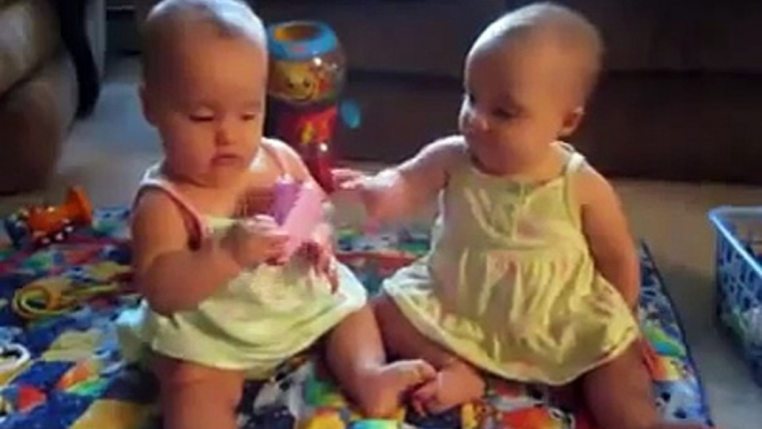 Funny Babies -- Twins fighting over cell