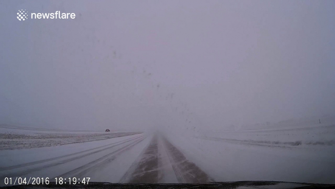 Car appears out of nowhere in horribly snowy conditions