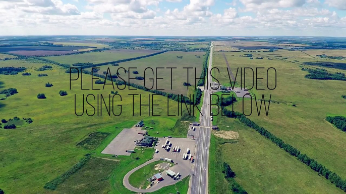 Aerial view of a highway with cars driving along a road. The gas station, hotel and road service