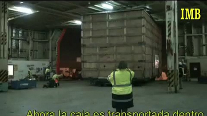 Shipment of a big wooden case on board a car carrier