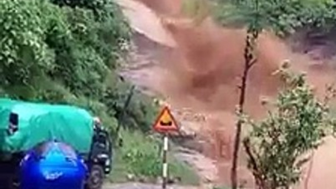 Chopper footage of damage from flash flooding and mudslides strand vehicles in Lao cai County