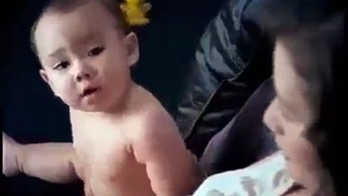 Funny cute baby gives diaper to his mom