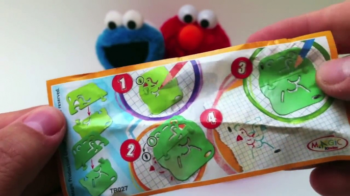 Elmo & Cookie Monster unwrapping Kinder Surprise Eggs Sesame Street