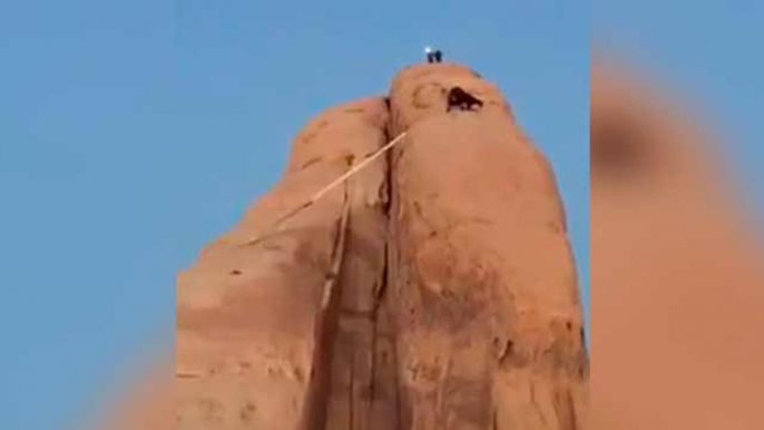 Saudi fire fighters rescuing goats that got stuck in a high big Rocky Mountain