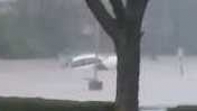 Floodwaters Submerge Car in Cincinnati Parking Lot