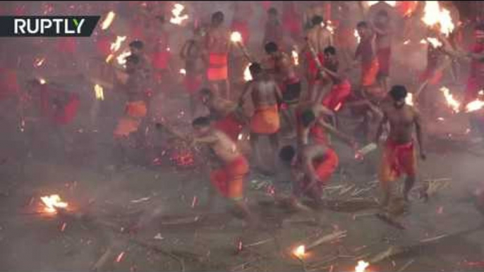 ‘Fire fight': Devotees brawl with burning palm fronds to appease Hindu goddess Durga