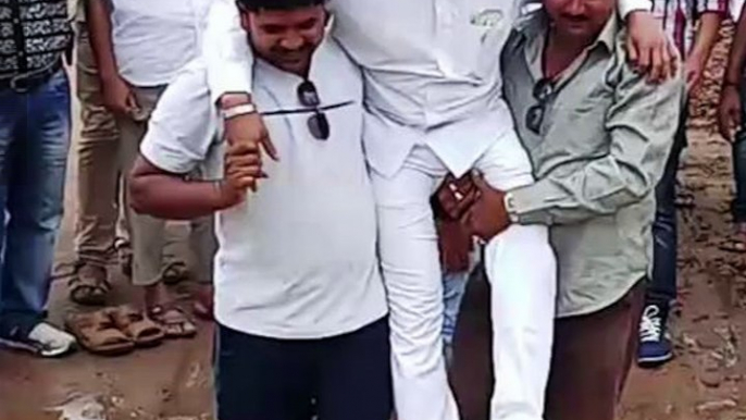 Odisha MLA lifted by supporters so his shoes don’t get wet