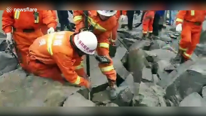 Hundreds of rescuers search for missing people after major landslide in China