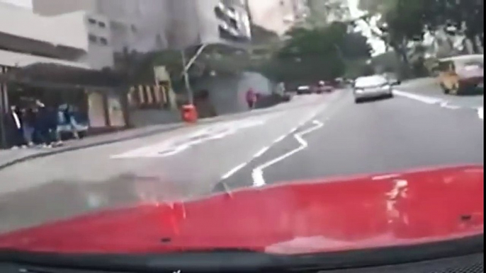 RAW  Man jumps head first into oncoming Car and smashes windshiled, Hong Kong