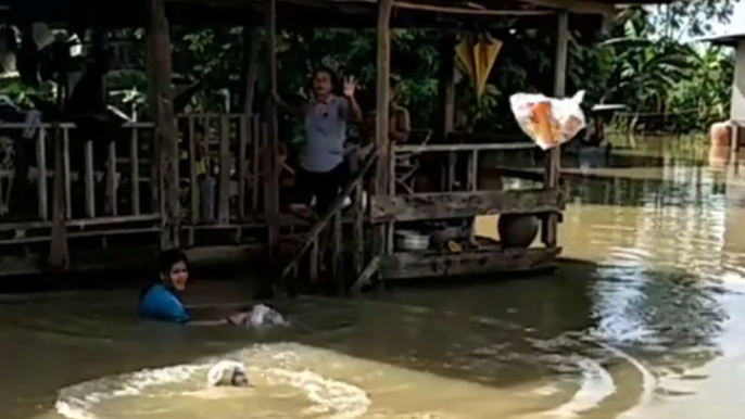 Relief Workers Throw Supplies to Locals Trapped by Floodwaters in Sakon Nakhon