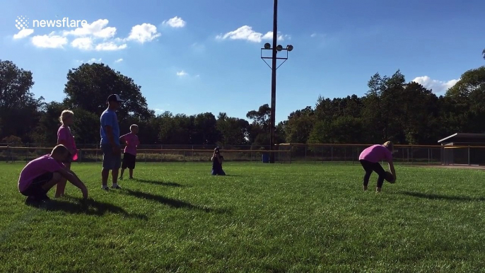 Family kick football to reveal baby's gender