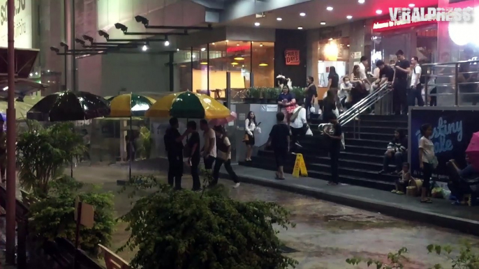 Security Guard Helps Shoppers Through Rain With Sun Umbrella