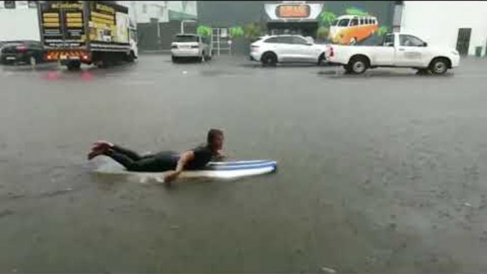 Surfer Takes to Flooded Streets as Storm Hits Durban