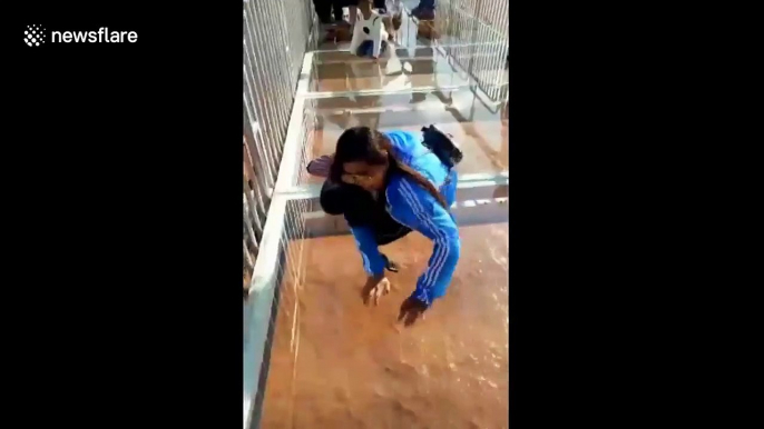 Tourist petrified by Yellow River's glass-bottomed bridge