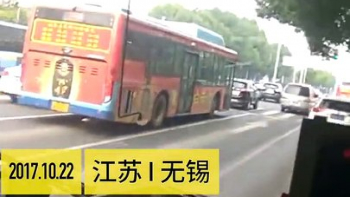 Chinese bus driver staring at his phone while driving