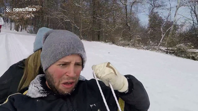 Brother and sister get faces full of snow when out sledding