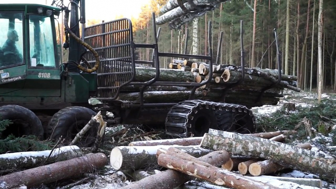 Timberjack 810B logging in winter forest