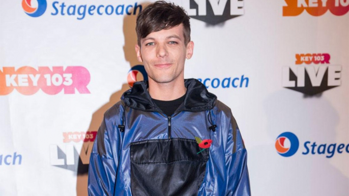 Louis Tomlinson discusses watching One Direction bandmates perform