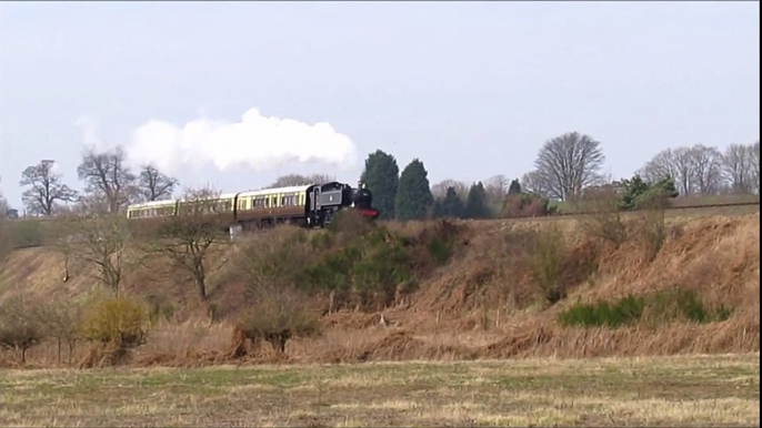 Steam Engine Pulling a Train of 3 Carriages along a Countryside Embankment on it's way to the Train Station