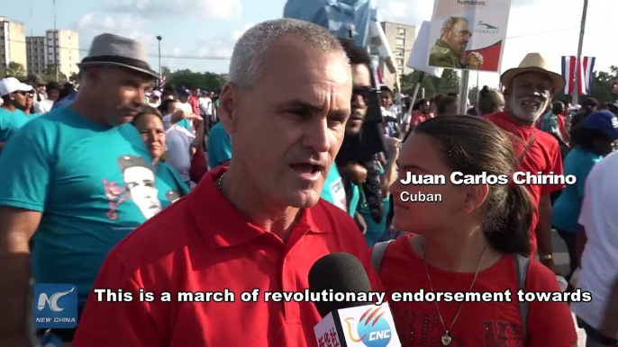 Town squares across Cuba turned into a sea of white, blue and red banners symbolizing the Cuban flag as nearly one million people marked International Workers'