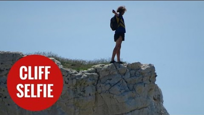 Idiots dangle over the edge of a crumbling cliff - to take SELFIES