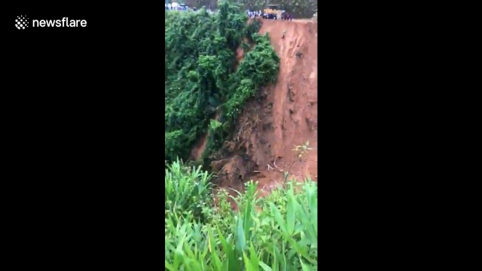 Terrifying moment two men escape death as landslide sweeps away road