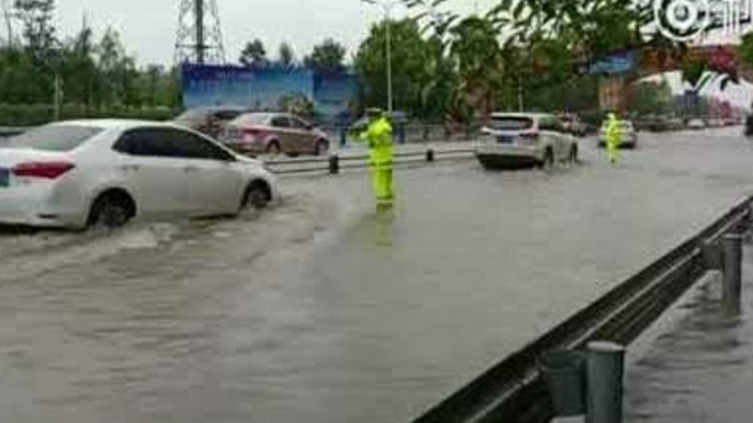 Chengdu Police Direct Traffic as Rain Floods City Streets