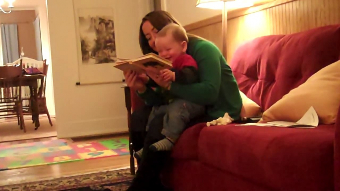 baby laughing at humor book