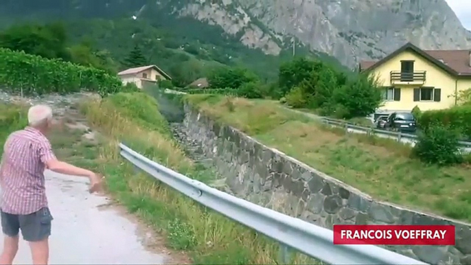 Watch People Stand By As Mudslide Flows Into Swiss Town