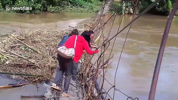 Dedicated teachers cross damaged bridge to reach school in Philippines