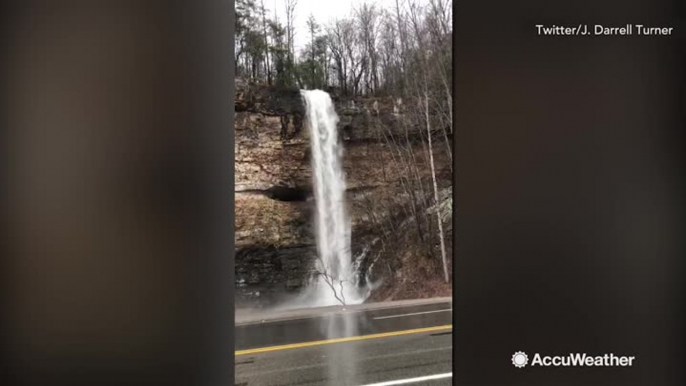 There's so much flooding, this waterfall forms on side of highway