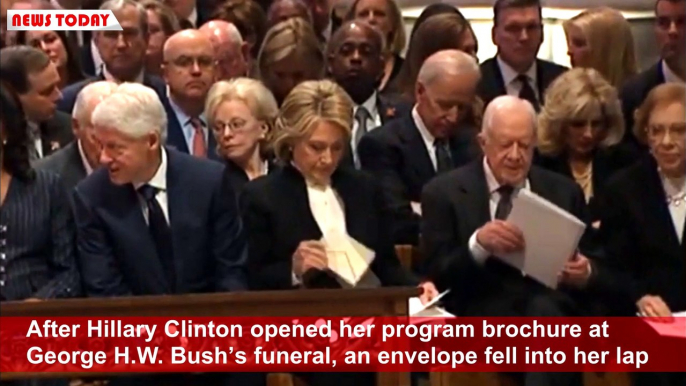 A Strange hidden envelope was given to Hillary Clinton at Bush funeral