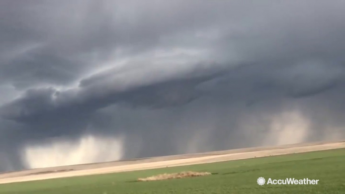 Storm clouds loom over flatland