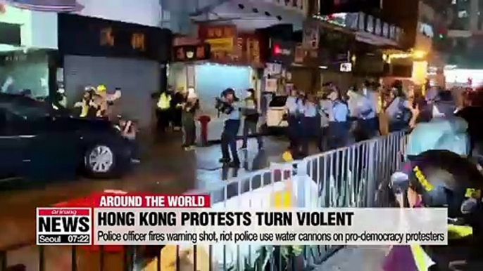 Hong Kong police fire live round warning shot and use water cannon on protesters